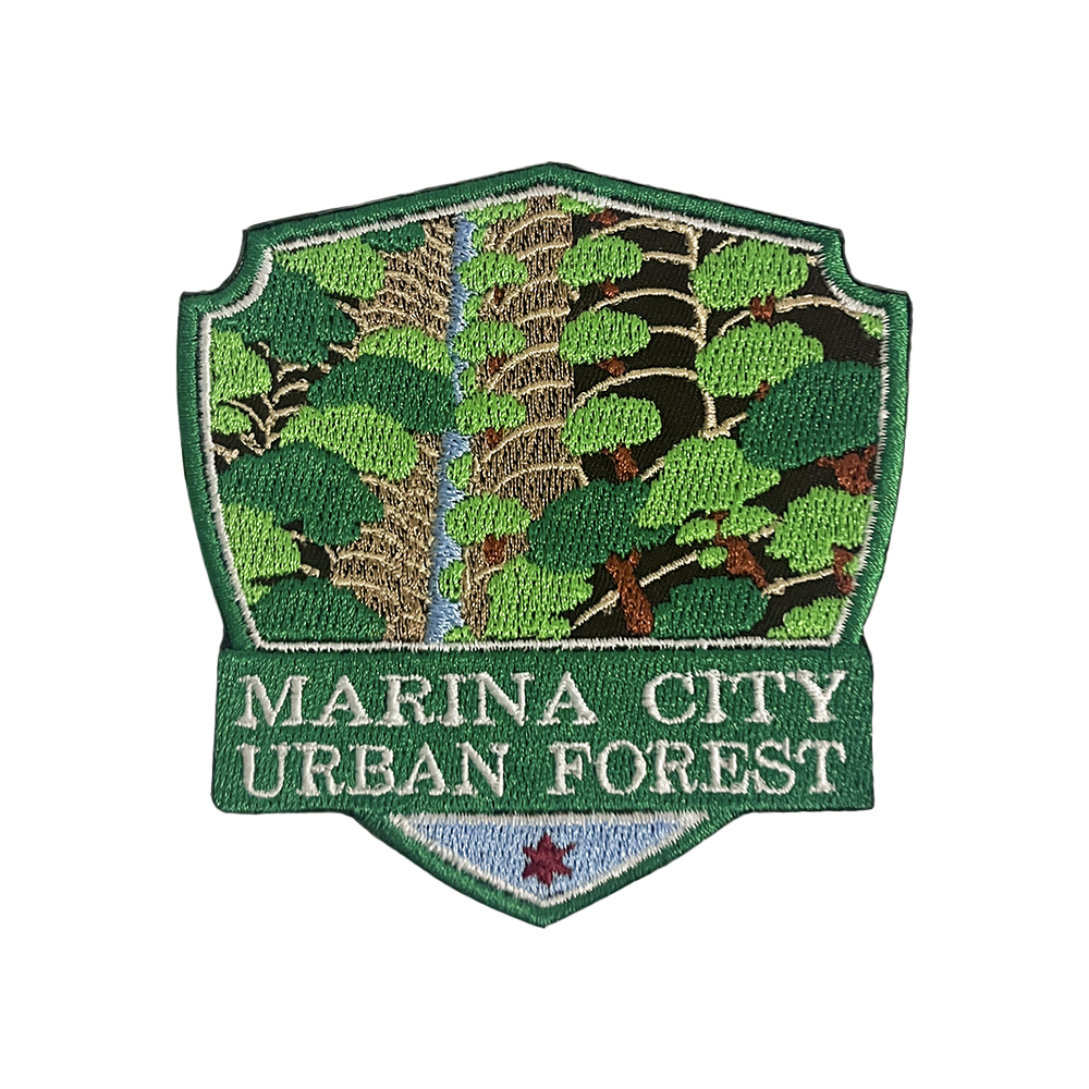 Shield-shaped patch illustration depicting Marina City towers covered in vegetation, labeled “Marina City Urban Forest.”