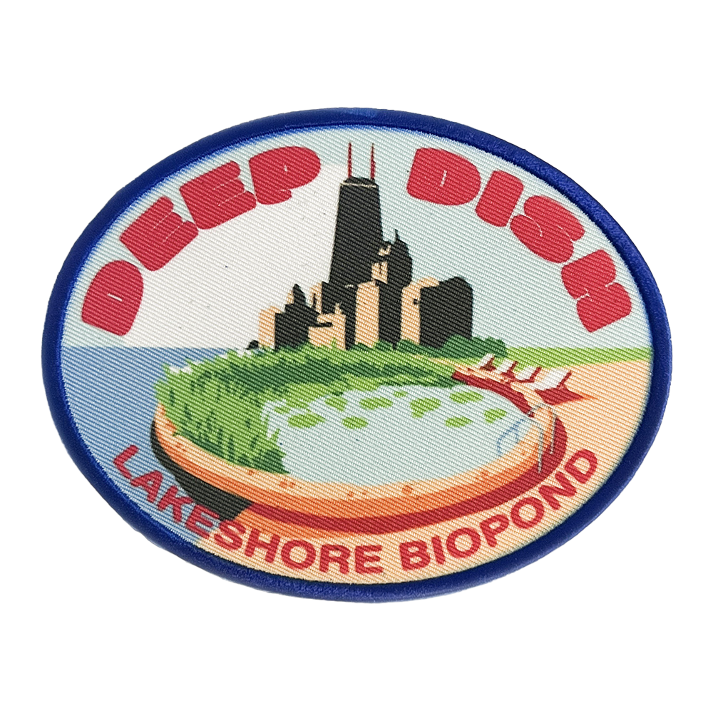 Circular patch illustration of Chicago’s skyline on a beach with a pond, labeled “Deep Dish Lakeshore Biopod.”